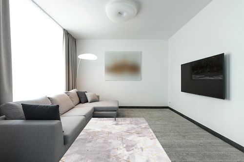 FINOREN Abstract Gold Line Area Rugs for Living Room,Bedroom,Hallway,Dining Room,Non-Shedding,Non Slip Backing,Floor Decoration Carpets,Gray-White,5x7 Feet in Modern Living Room with Grey Couch