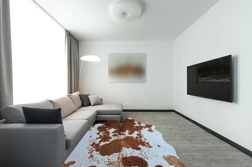 rugoo Premium Brown Cowhide Rug 6.4 ft x 8.5 ft Faux Cowhide Rug Cow Print Rug Faux Animal Skin Rug for Living Room Bedroom Nursery Western Decor in Modern Living Room with Grey Couch