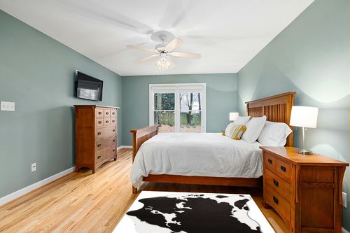 MACEVIA Faux Cowhide Rug Cute Cow Print Rug Animal Area Carpet Western Decor for Living Room Bedroom Non-Slip 59" L x 47.2" W(4.9ft x 3.9ft) Black and White in Teal and Orange Wood Bedroom