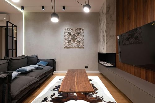 Sunshine Cowhides Genuine Tricolor Cowhide Rug - Luxurious Cow Rug for Bedroom, Living Room, and Home Decor Enthusiasts - Masterpiece of Style and Functionality - 6x6-7ft (180x210cm) in Dark Wood Living Room with Black Couch