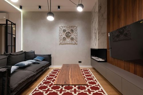 SAFAVIEH Cambridge Collection 6' x 9' Rust / Ivory CAM125L Handmade Moroccan Premium Wool Area Rug in Dark Wood Living Room with Black Couch