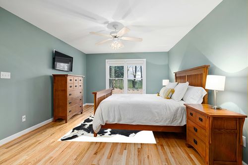 HIDES BAZAAR Dark Tricolor Cowhide Rug, Premium Quality Genuine Leather Cow Hide, Dark Brown, Black and White Area Rug (6x7 ft) in Teal and Orange Wood Bedroom