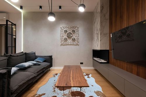 rugoo Premium Brown Cowhide Rug 6.4 ft x 8.5 ft Faux Cowhide Rug Cow Print Rug Faux Animal Skin Rug for Living Room Bedroom Nursery Western Decor in Dark Wood Living Room with Black Couch
