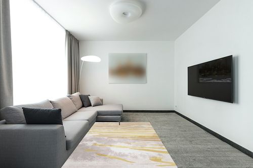 FINOREN Modern Area Rug,Line Swoosh Soft Non-Slip Rug for Bedroom Living Room Hallway Dining Room Office Dorm Room,Washable Low Pile Floor Decor,Child Pet Friendly,Grey Gold,5x7 Feet in Modern Living Room with Grey Couch