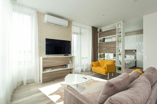 Signature Design by Ashley Jaxith Farmhouse 5 x 7 Medium Pile Cowhide Rug, Ivory & Tan in Light Modern Living Room with TV