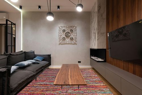 Cotton Multi Chindi Hand Woven Rugs THE BEER VALLEY in Dark Wood Living Room with Black Couch