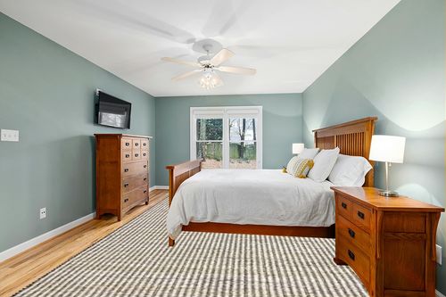 Loloi Angela Rose x Colton Ivory/Black 10'-0" x 14'-0" Area Rug in Teal and Orange Wood Bedroom