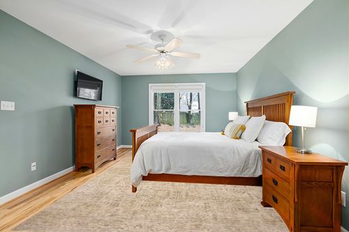 Loloi Magnolia Home by Joanna Gaines Junie Collection JUE-02 Oatmeal/Smoke 9'-6" x 13', .38" Pile Height, Area Rug in Teal and Orange Wood Bedroom