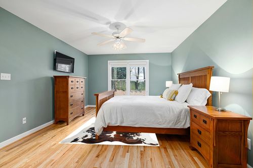 Sunshine Cowhides Genuine Tricolor Cowhide Rug - Luxurious Cow Rug for Bedroom, Living Room, and Home Decor Enthusiasts - Masterpiece of Style and Functionality - 6x6-7ft (180x210cm) in Teal and Orange Wood Bedroom