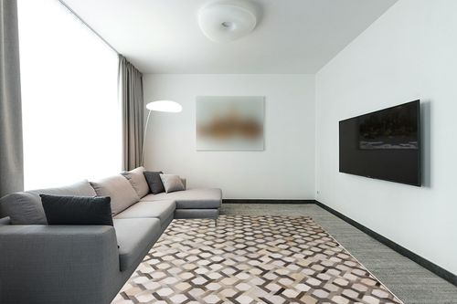 Blackamoor Leather Hide Patchwork Area Rug Handmade Cowhide Contemporary Grey Style (6'x9' ft) in Modern Living Room with Grey Couch