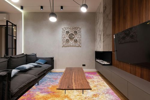 Nourison Passion Bohemian Abstract Sunburst Area Rug, (8' x 10') in Dark Wood Living Room with Black Couch