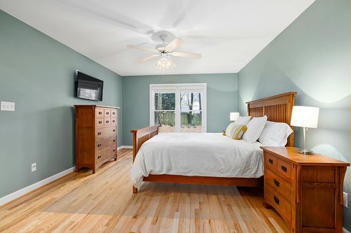 Linon Haven Lux Soft Faux Rabbit White Solid Colored 8' X 10' Area Rug in Teal and Orange Wood Bedroom