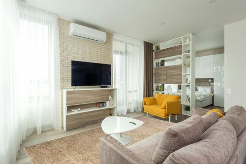 Loloi Magnolia Home by Joanna Gaines Junie Collection JUE-02 Oatmeal/Smoke 7'-10" x 10'-2", .38" Pile Height, Area Rug in Light Modern Living Room with TV