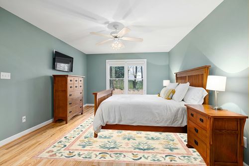 Loloi Rifle Paper Co. x Eden Mughal Rose Blush 8'-6" x 11'-6" Area Rug in Teal and Orange Wood Bedroom