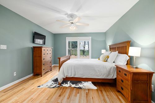 Sunshine Cowhides Genuine Tricolor Cow Skin Leather Cowhide Rug - Luxurious Cow Rug for Bedroom, Living Room, and Home Decor Enthusiasts - Masterpiece of Style and Functionality - XL 6x7-8ft in Teal and Orange Wood Bedroom