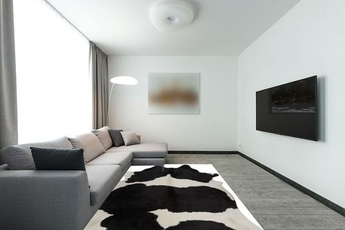 rodeo Classic Black and White Cowhide Rug … in Modern Living Room with Grey Couch