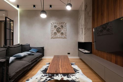 Sunshine Cowhides Genuine Tricolor Cow Skin Leather Cowhide Rug - Luxurious Cow Rug for Bedroom, Living Room, and Home Decor Enthusiasts - Masterpiece of Style and Functionality - XL 6x7-8ft in Dark Wood Living Room with Black Couch