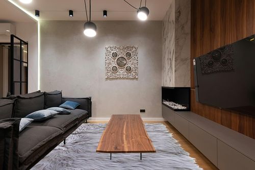 Ultra Soft & Fluffy Faux Sheepskin Rug in Dark Wood Living Room with Black Couch
