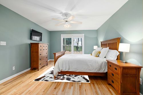 Sunshine Cowhides Genuine Tricolor Spotted Cowhide Rug - Luxurious Cow Rug for Bedroom, Living Room, and Home Decor Enthusiasts - Masterpiece of Style and Functionality - 6x6-7ft (180x210cm) in Teal and Orange Wood Bedroom