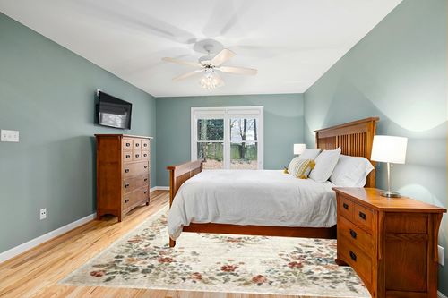 Loloi Rifle Paper Co. x Laurel Cream 9'-2" x 12'-2" Area Rug in Teal and Orange Wood Bedroom