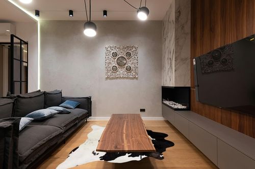 Cowhides Direct Genuine Cowhide Rug - Black & White Rug for Living Room, Bedroom & More - Authentic Cow Rug (6’x7’ Black & White) in Dark Wood Living Room with Black Couch