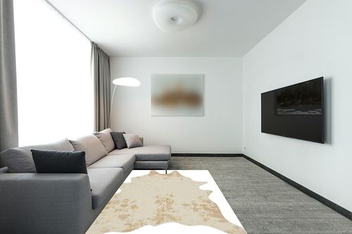 Signature Design by Ashley Jaxith Farmhouse 5 x 7 Medium Pile Cowhide Rug, Ivory & Tan in Modern Living Room with Grey Couch