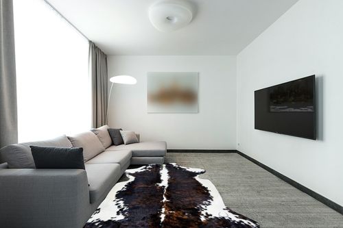 rodeo Cowhide Rug Dark Brindle Size 6x8 Feet Dc in Modern Living Room with Grey Couch