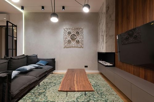 Loloi Magnolia Home by Joanna Gaines x Sinclair Jade/Sand 8'-6" x 11'-6" Area Rug in Dark Wood Living Room with Black Couch