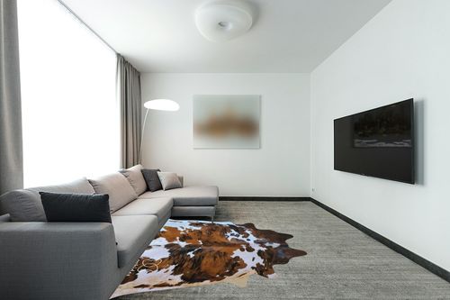 ecowhides 100% Genuine Brazilian Cowhide Rug - Tricolor, Brown, Black & White - Luxury Cowskin Leather Area Rug Decor, (X-Large) 7 x 6 ft in Modern Living Room with Grey Couch