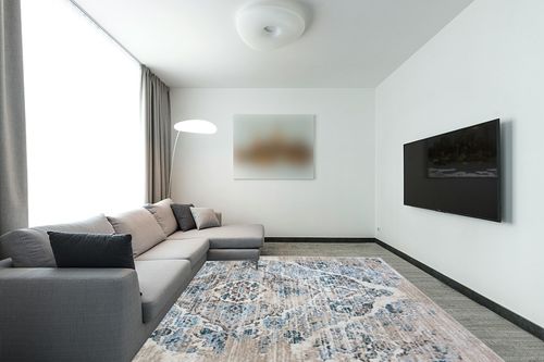 Cream Modern Stain Resistant, Durable, Fade Resistant Area Rug in Modern Living Room with Grey Couch