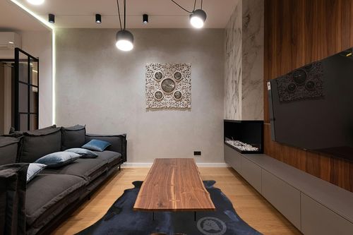 Sunshine Cowhides Genuine Black Cowhide Rug - Luxurious Cow Rug for Bedroom, Living Room, and Home Decor Enthusiasts - Masterpiece of Style and Functionality - XL 6x7-8ft (180x220cm) in Dark Wood Living Room with Black Couch