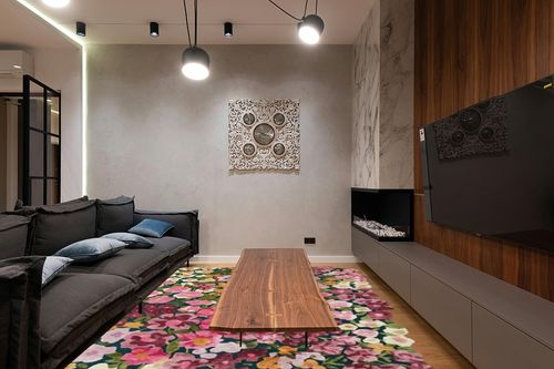 Restoration and Renovation Handmade Colorful Flower Silk & Wool Area Rug | Spring Garden Overflows The Frame | Unique Irregular Shape Hand-Tufted Floral Rug Perfect for Home Decor (5x8 Feet) in Dark Wood Living Room with Black Couch