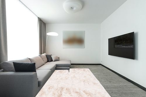 6' x 9' Ivory fluffy rug in Modern Living Room with Grey Couch