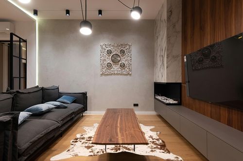 nuLOOM Iraida Contemporary Faux Cowhide Area Rug, 5' x 6' 7", Brown in Dark Wood Living Room with Black Couch