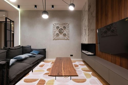 HOMBYS 9x12ft Boho Area Rug for Living Room Bedroom, Large Floor Carpet for Indoor Office Dining Room, Modern Home Deco Non-Shedding, Orange, Machine Washable in Dark Wood Living Room with Black Couch