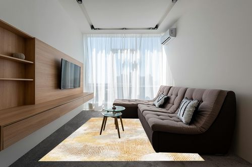 Art&Tuft Washable Rug in Grey Living Room with Brown Couch