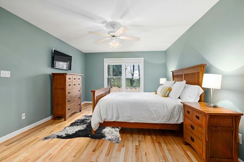 Luxe Faux Cowhide Rug for Rustic and Western Decor | Low Pile Faux Fur Rug with Salt/Pepper Black + White Cow Print | Cruelty-Free Fade Resistant Living Room Rugs | 5-1/4 x 7-1/2 ft in Teal and Orange Wood Bedroom