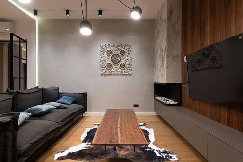 rodeo Genuine Cowhide Rug: Hand-Picked & Authentic Real Cowhide Rug for western Home Decor - Cow Hide Rug Large Sized at 6x7ft - Rustic rug, Unique, Durable, Leather Cow Carpet Rugs - Brindle cowhide rug in Dark Wood Living Room with Black Couch