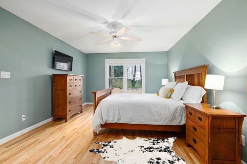 nuLOOM Marcia Machine Washable Faux Cowhide Accent Rug, 3' 10" x 5', Black in Teal and Orange Wood Bedroom