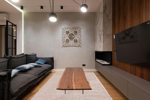 Unique Loom Solid Shag Collection Area Rug (6' 1" x 9' Rectangle, Taupe) in Dark Wood Living Room with Black Couch