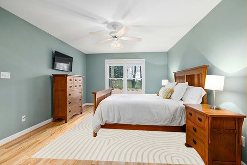 Ayjah Cream Modern Geometric Area Rug Wade Logan Rug Size: Rectangle 8'9" x 12' in Teal and Orange Wood Bedroom