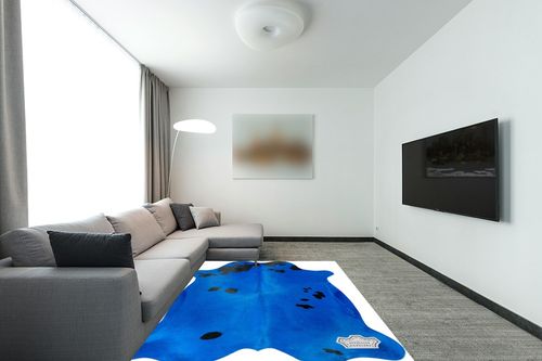 Appaloosa Cowhides Color Dyed Collection (Vibrant Blue) in Modern Living Room with Grey Couch