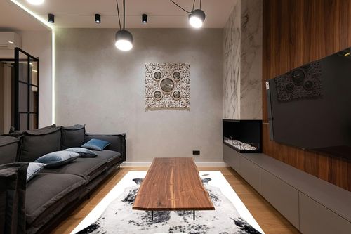 nuLOOM Halina Faux Cowhide Area Rug, 5' 9" x 7' 7", Black in Dark Wood Living Room with Black Couch