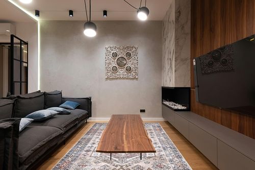 nuLOOM Mae Tribal Motif Machine Washable Area Rug in Dark Wood Living Room with Black Couch