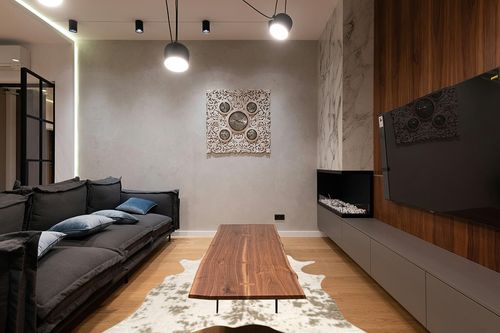 nuLOOM Marcia Machine Washable Faux Cowhide Area Rug, 5' 9" x 7' 7", Off White in Dark Wood Living Room with Black Couch