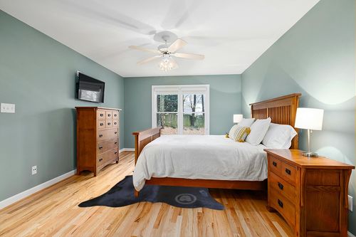 Sunshine Cowhides Genuine Black Cowhide Rug - Luxurious Cow Rug for Bedroom, Living Room, and Home Decor Enthusiasts - Masterpiece of Style and Functionality - XL 6x7-8ft (180x220cm) in Teal and Orange Wood Bedroom