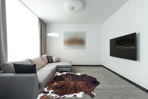 rodeo Classic Brown Brindle Cowhide Rug XXL 6x8 Ft in Modern Living Room with Grey Couch