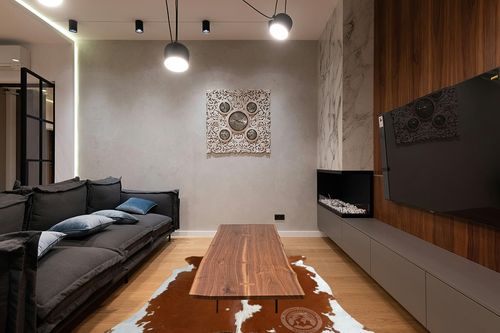 Genuine Brown and White Cowhide Rug XL 6 x 7-8 ft. 180 x 240 cm in Dark Wood Living Room with Black Couch