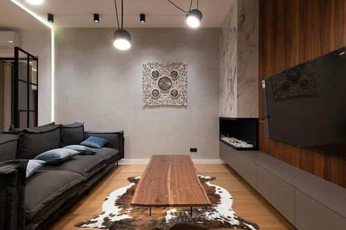 HIDES BAZAAR Brown Brindle Cowhide Rug, Premium Quality Genuine Leather Cow Hide, Brown, Black and White Area Rug (6x7 ft) in Dark Wood Living Room with Black Couch