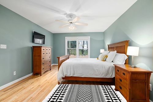 HEBE Bohe Area Rug in Teal and Orange Wood Bedroom